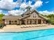 Community pool and clubhouse featuring an outdoor lounge area and well-manicured landscaping at 308 Hollister Estates Dr, Waxhaw, NC 28173