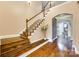 Staircase boasts hardwood treads, white risers, and arched entryway to another room at 308 Hollister Estates Dr, Waxhaw, NC 28173