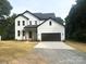 Charming, modern farmhouse with white siding, black trim, and a spacious two-car garage at 3114 Ansonville Rd, Marshville, NC 28103