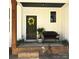 Inviting front porch with craftsman details, black front door with wreath, and a comfy bench at 3114 Ansonville Rd, Marshville, NC 28103