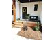 Charming front porch with brick steps, bench seating, and a beautiful wreath on the door at 3114 Ansonville Rd, Marshville, NC 28103