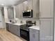 The kitchen features gray cabinets, stainless steel appliances, quartz countertops, and mosaic backsplash at 3114 Ansonville Rd, Marshville, NC 28103