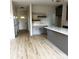 Open-concept kitchen area featuring wood-look floors, gray cabinets, and a spacious center island at 3114 Ansonville Rd, Marshville, NC 28103
