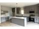 Well-designed kitchen with stainless steel appliances, center island with quartz countertop, and gray cabinets at 3114 Ansonville Rd, Marshville, NC 28103