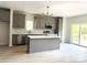 Stylish kitchen featuring gray cabinets, quartz counters, stainless appliances, and sliding door access to a deck at 3114 Ansonville Rd, Marshville, NC 28103