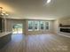 Open living room featuring a modern fireplace, large windows, and access to a deck at 3114 Ansonville Rd, Marshville, NC 28103