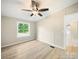 A quiet bedroom with a ceiling fan and a window offering a view of the green outdoors at 317 Berry Trl, Wadesboro, NC 28170