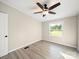 Bright bedroom features a ceiling fan, light walls, and modern floors at 317 Berry Trl, Wadesboro, NC 28170