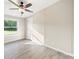 A tranquil bedroom features neutral tones, vinyl flooring, and a window with a green view at 317 Berry Trl, Wadesboro, NC 28170