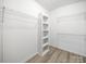 Walk-in closet featuring neutral wall colors, laminate floors, and white wire shelving at 317 Berry Trl, Wadesboro, NC 28170
