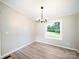A bright dining area with a modern chandelier and a view of the outdoors through a window at 317 Berry Trl, Wadesboro, NC 28170