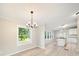 Open floor plan dining room with stylish chandelier, large window and modern floors at 317 Berry Trl, Wadesboro, NC 28170