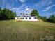 Charming single-story home featuring a welcoming wooden porch and green shutters on a spacious lawn at 317 Berry Trl, Wadesboro, NC 28170