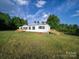 Charming single story home with beautiful green lawn and classic finishes, with wooden deck and stairs at 317 Berry Trl, Wadesboro, NC 28170