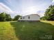 Exterior of the home surrounded by lush green grass and trees in a quiet, serene neighborhood at 317 Berry Trl, Wadesboro, NC 28170