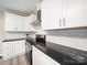 Beautiful kitchen featuring white cabinetry, black granite countertops and a stainless steel range hood at 317 Berry Trl, Wadesboro, NC 28170