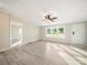 Inviting living room with large windows, a modern ceiling fan, light-colored walls, and light-tone laminate flooring at 317 Berry Trl, Wadesboro, NC 28170