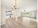 A brightly lit, open-concept living room features light-colored walls and floors, seamlessly connecting to the kitchen at 317 Berry Trl, Wadesboro, NC 28170