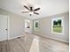 Light and airy main bedroom with bright walls, windows, modern flooring, and ceiling fan at 317 Berry Trl, Wadesboro, NC 28170