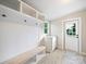 Functional mudroom featuring built-in bench with storage, cubbies, hooks, and an exterior door to the right at 317 Berry Trl, Wadesboro, NC 28170