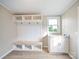 Functional mudroom featuring built-in bench with storage, cubbies, hooks, and a window above the sink at 317 Berry Trl, Wadesboro, NC 28170