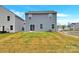 Backyard features vinyl siding, sliding glass doors, and green grass under a blue sky at 3212 Coast Oak Rd, Charlotte, NC 28214