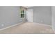 A serene bedroom with neutral walls, carpeted floors, and a window at 3212 Coast Oak Rd, Charlotte, NC 28214
