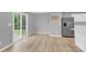 Open dining area featuring wood floors, stainless steel fridge, and a large window with a view at 3212 Coast Oak Rd, Charlotte, NC 28214