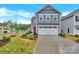 Two-story home with gray siding, white trim, a bright red front door, and an attached white two-car garage at 3212 Coast Oak Rd, Charlotte, NC 28214