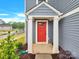 Close up of the bright red front door with white trim and siding at 3212 Coast Oak Rd, Charlotte, NC 28214