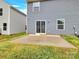 Concrete patio with sliding glass doors to the house, plus green grass at 3212 Coast Oak Rd, Charlotte, NC 28214