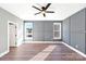 Comfortable bedroom with natural light, featuring neutral gray walls and wood-look floors at 32507 Buchanan Ln, Albemarle, NC 28001