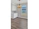 Elegant dining space with a chandelier, complemented by white cabinets and natural light at 32507 Buchanan Ln, Albemarle, NC 28001