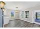 Inviting dining area with chandelier lighting, ample natural light, and easy access to the outdoors at 32507 Buchanan Ln, Albemarle, NC 28001