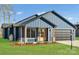 Charming home with a blue exterior, complemented by a well-manicured lawn and inviting front porch at 32507 Buchanan Ln, Albemarle, NC 28001