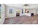 Open-concept living room with fireplace flows seamlessly into the kitchen, featuring modern finishes at 32507 Buchanan Ln, Albemarle, NC 28001