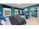 Spacious bedroom with three windows and unique teal paint at 4210 Steel Way, Sherrills Ford, NC 28673