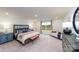 Spacious main bedroom with plush bedding, comfortable seating, and a serene outdoor view at 4210 Steel Way, Sherrills Ford, NC 28673