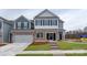 Charming two-story home with stone accents, well-manicured lawn, and an attached two-car garage at 4216 Steel Way, Sherrills Ford, NC 28673