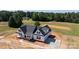 A new construction home sits on a large lot featuring a sleek, black roof, a white exterior, and an attached garage at 4648 Simpson Rd, Edgemoor, SC 29712