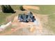 Areal view of a charming new build featuring a black roof, a white exterior, and a concrete driveway at 4648 Simpson Rd, Edgemoor, SC 29712