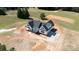 New construction home with black roof and white exterior is beautifully set on a large lot with fresh concrete driveway at 4648 Simpson Rd, Edgemoor, SC 29712