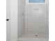 Modern tiled shower with glass and a built-in niche for toiletries at 4648 Simpson Rd, Edgemoor, SC 29712
