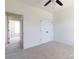 Bright bedroom featuring neutral carpet, ceiling fan, and access to the rest of the house at 4648 Simpson Rd, Edgemoor, SC 29712