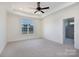 Spacious bedroom featuring plush carpet, tray ceiling and a view to a tiled bathroom at 4648 Simpson Rd, Edgemoor, SC 29712