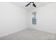 This bright bedroom has neutral carpet, a ceiling fan, and a window with views of the yard at 4648 Simpson Rd, Edgemoor, SC 29712