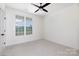 Bright bedroom features a ceiling fan and a large window offering plenty of natural light at 4648 Simpson Rd, Edgemoor, SC 29712