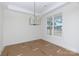 Bright dining room with a large window, elegant chandelier, and neutral paint at 4648 Simpson Rd, Edgemoor, SC 29712
