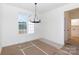 Bright dining room with a large window, elegant chandelier, and neutral paint at 4648 Simpson Rd, Edgemoor, SC 29712