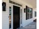 Inviting entrance showcasing a modern black front door with sidelights and stylish exterior lighting fixtures at 4648 Simpson Rd, Edgemoor, SC 29712
